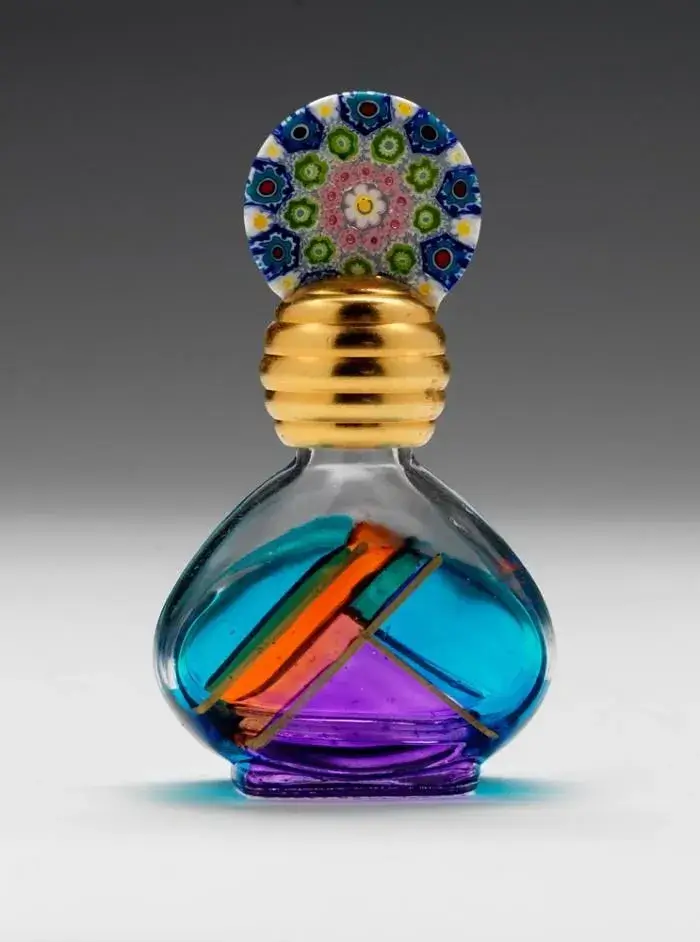 Close-up of the intricate design of an ORA perfume bottle cap.